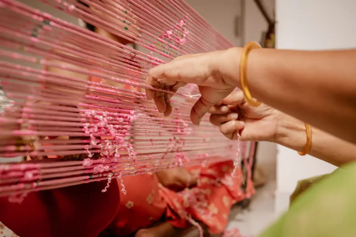 A close up of a rich Patola silk outfit highlighting intricate double ikat weaving, natural dyed colours, and traditional motifs crafted by skilled artisans.